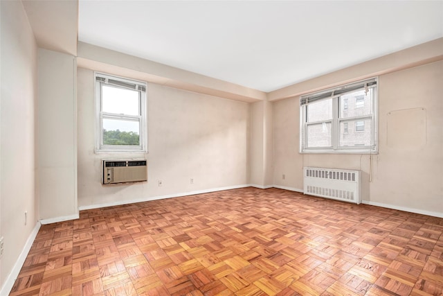 33 Barker Ave Unit 6K, White Plains, NY 10601 - spare room featuring radiator heating unit, healthy amount of natural light, and an AC wall unit