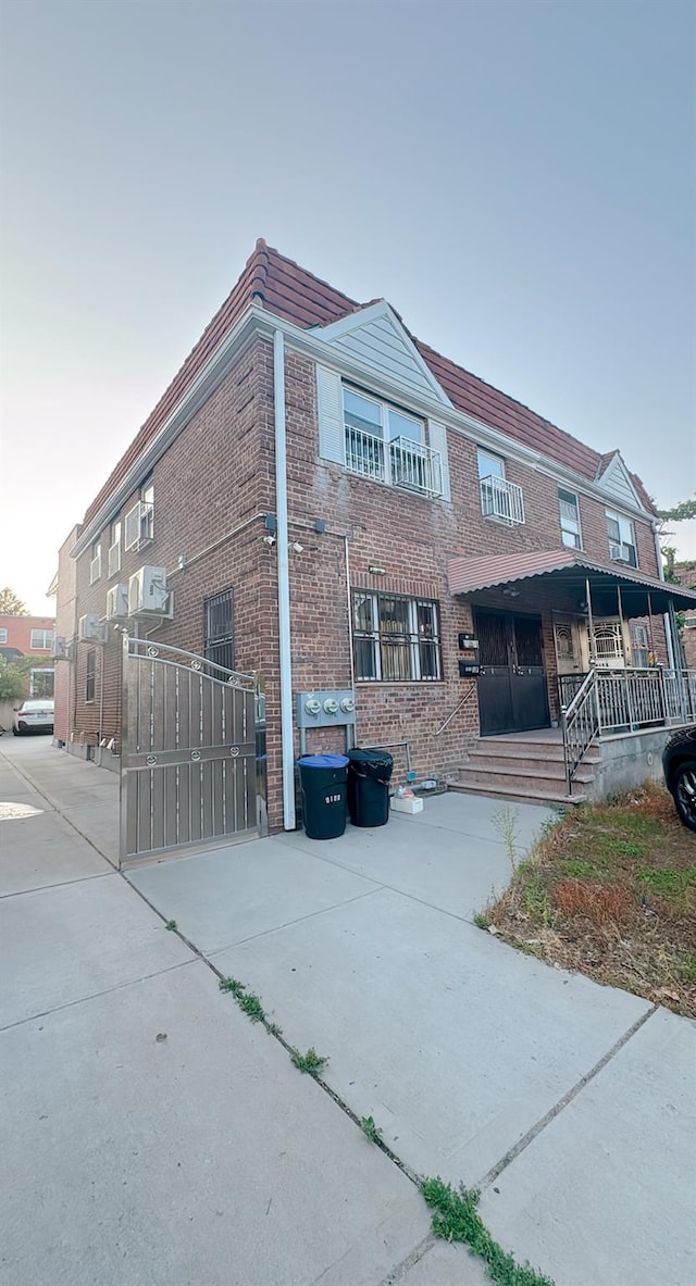 61-40 148th St, Flushing, NY 11367 - view of side of home featuring brick siding and a gate