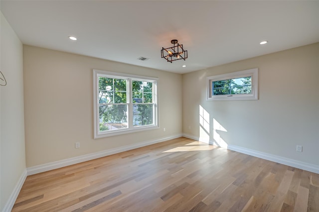 100 Root Ave, Islip, NY 11751 - empty room with plenty of natural light, light wood finished floors, recessed lighting, and a chandelier