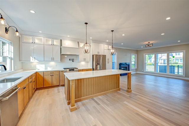 100 Root Ave, Islip, NY 11751 - kitchen with stainless steel appliances, light wood finished floors, recessed lighting, a center island, and light countertops