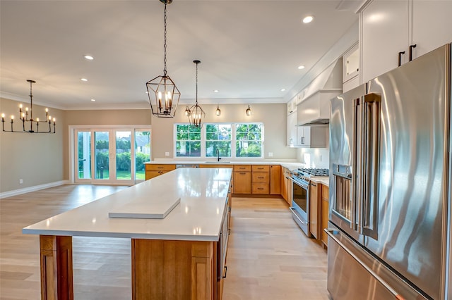 100 Root Ave, Islip, NY 11751 - kitchen with high quality appliances, a chandelier, light wood-style flooring, light countertops, and a center island