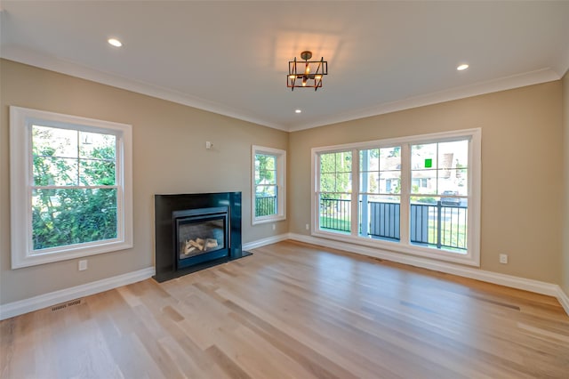100 Root Ave, Islip, NY 11751 - unfurnished living room featuring light wood-type flooring, crown molding, recessed lighting, and a fireplace with flush hearth