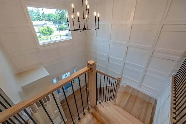 100 Root Ave, Islip, NY 11751 - staircase featuring a chandelier, wood finished floors, and a decorative wall
