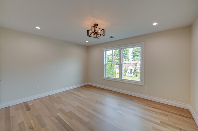 100 Root Ave, Islip, NY 11751 - unfurnished room featuring light wood-style floors, a chandelier, and recessed lighting