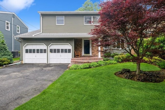 1581 Shirley Ct, North Merrick, NY 11566 - view of front facade featuring asphalt driveway, a front yard, an attached garage, and brick siding