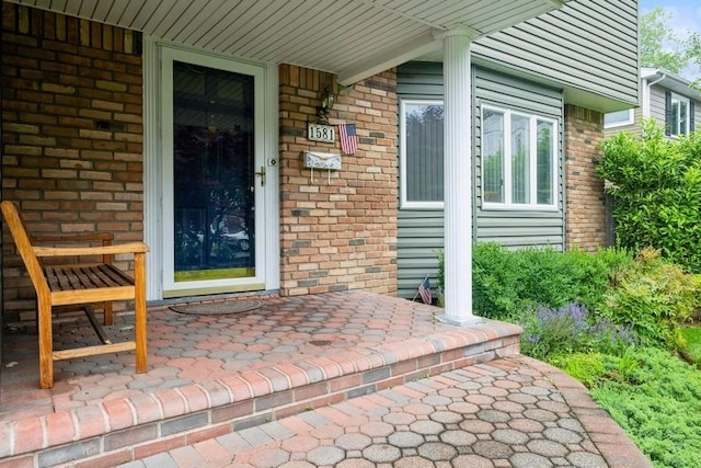 1581 Shirley Ct, North Merrick, NY 11566 - entrance to property featuring brick siding and covered porch