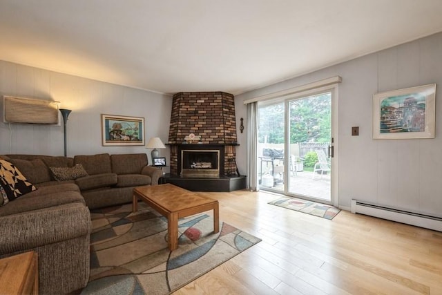 1581 Shirley Ct, North Merrick, NY 11566 - living area with wood finished floors, a brick fireplace, and a baseboard heating unit