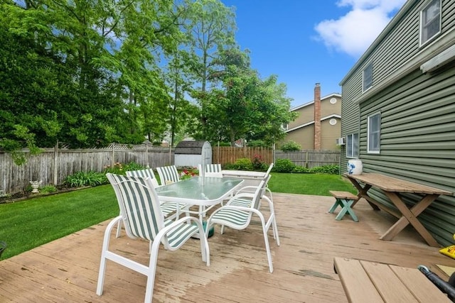 1581 Shirley Ct, North Merrick, NY 11566 - deck with outdoor dining area, a shed, and a fenced backyard