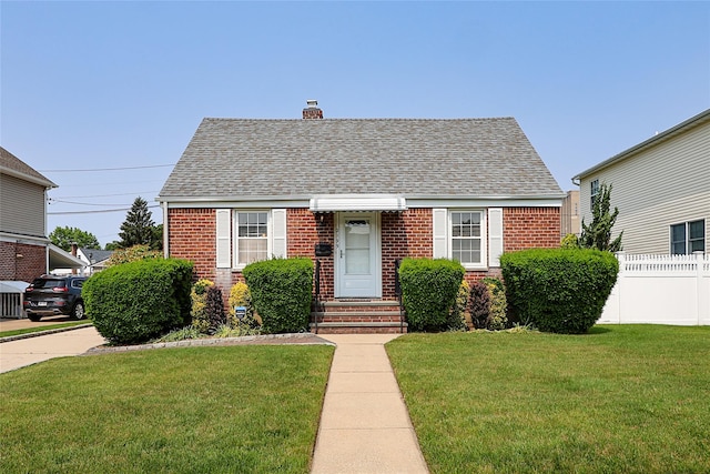 2199 Mcarthur St, East Meadow, NY 11554 - view of front of property with brick siding, a shingled roof, a chimney, and entry steps