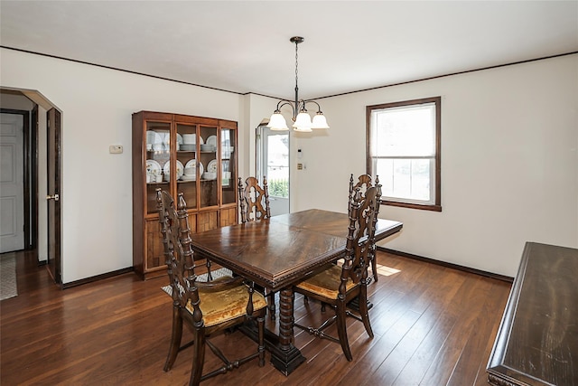 2199 Mcarthur St, East Meadow, NY 11554 - dining space featuring dark wood-style flooring, arched walkways, and a chandelier
