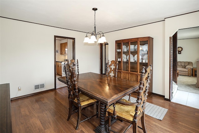 2199 Mcarthur St, East Meadow, NY 11554 - dining room featuring a chandelier and wood finished floors