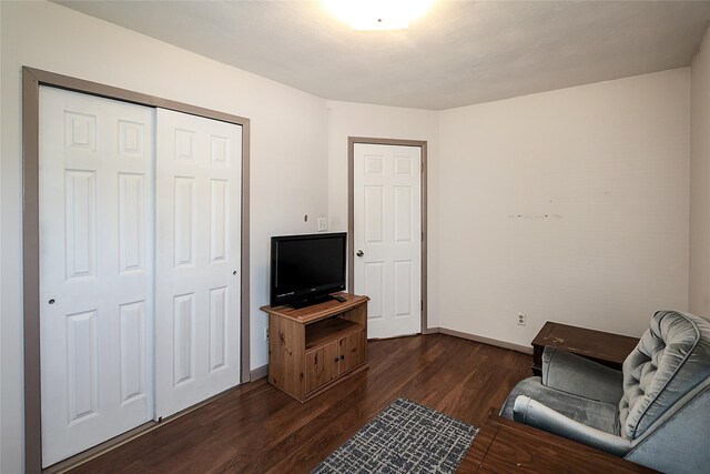 2199 Mcarthur St, East Meadow, NY 11554 - living area featuring dark wood finished floors and baseboards