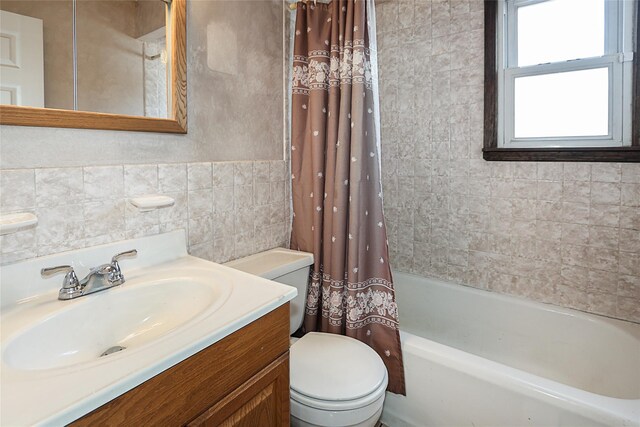 2199 Mcarthur St, East Meadow, NY 11554 - bathroom featuring tile walls, vanity, and shower / tub combo