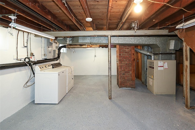2199 Mcarthur St, East Meadow, NY 11554 - unfinished below grade area featuring washing machine and clothes dryer, electric panel, and heating unit