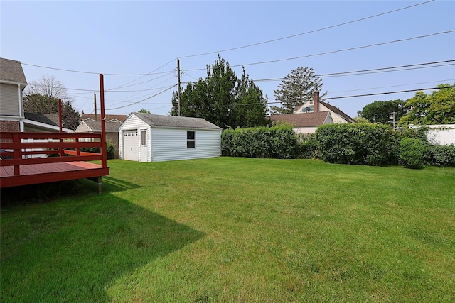 2199 Mcarthur St, East Meadow, NY 11554 - view of grassy yard featuring a garage, an outdoor structure, and a wooden deck