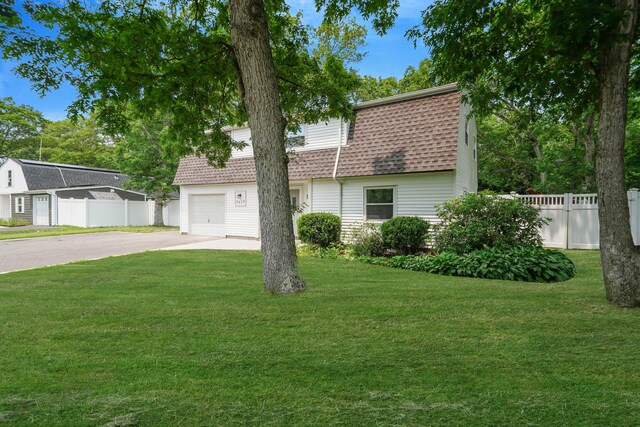 5439 Expressway Dr N, Holtsville, NY 11742 - colonial inspired home featuring roof with shingles, asphalt driveway, and a garage