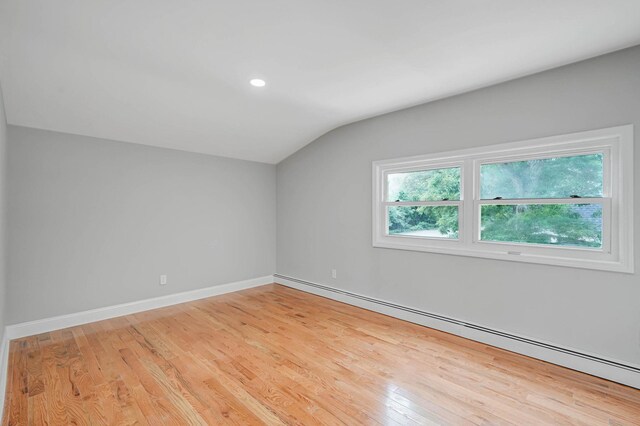 5439 Expressway Dr N, Holtsville, NY 11742 - additional living space featuring baseboard heating, lofted ceiling, light wood-style floors, and recessed lighting