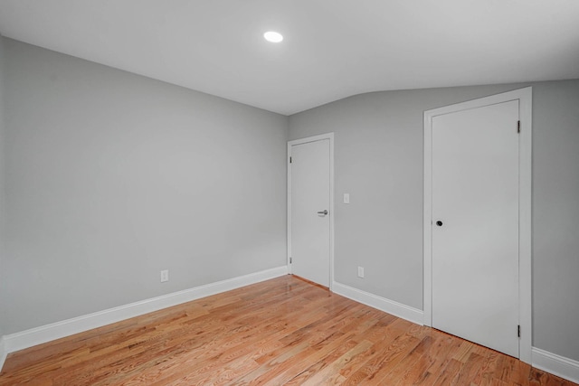 5439 Expressway Dr N, Holtsville, NY 11742 - unfurnished bedroom featuring light wood-type flooring and lofted ceiling