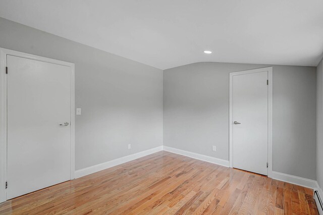 5439 Expressway Dr N, Holtsville, NY 11742 - bonus room with vaulted ceiling, light wood finished floors, a baseboard radiator, and recessed lighting