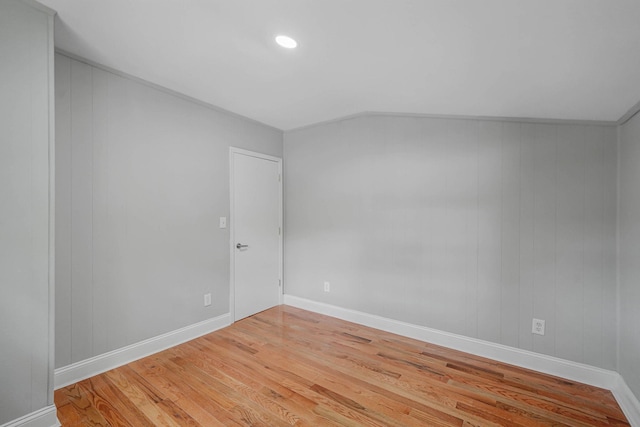5439 Expressway Dr N, Holtsville, NY 11742 - unfurnished room featuring wood finished floors, lofted ceiling, and recessed lighting