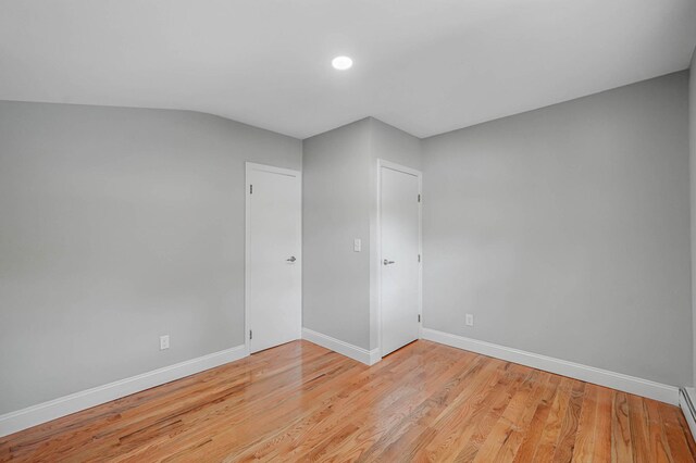 5439 Expressway Dr N, Holtsville, NY 11742 - unfurnished room with a baseboard radiator, light wood-style flooring, and recessed lighting