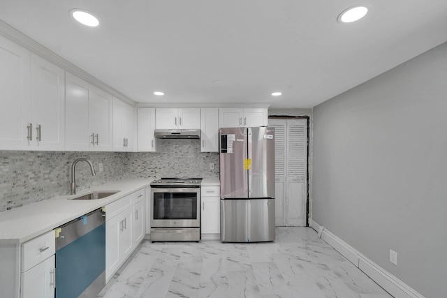 5439 Expressway Dr N, Holtsville, NY 11742 - kitchen featuring appliances with stainless steel finishes, under cabinet range hood, light countertops, recessed lighting, and light marble finish floors