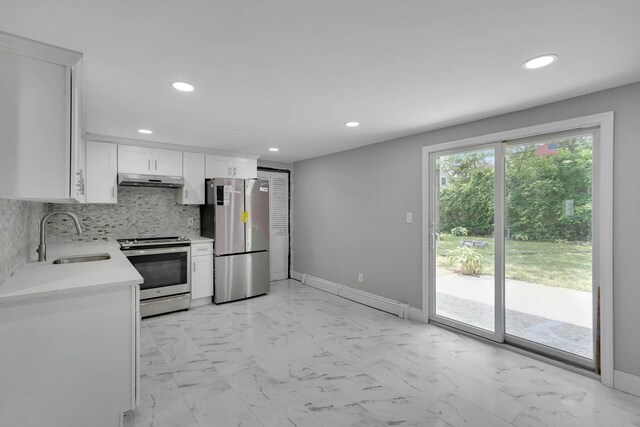 5439 Expressway Dr N, Holtsville, NY 11742 - kitchen featuring appliances with stainless steel finishes, light countertops, recessed lighting, white cabinets, and under cabinet range hood