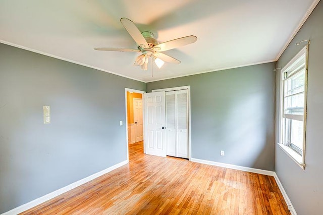 83 Bellerose Ave, East Northport, NY 11731 - unfurnished bedroom with a closet, light wood-style flooring, ornamental molding, and ceiling fan