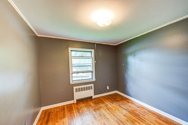 83 Bellerose Ave, East Northport, NY 11731 - unfurnished room featuring radiator, crown molding, and wood-type flooring