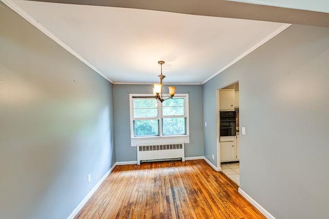 83 Bellerose Ave, East Northport, NY 11731 - unfurnished dining area with radiator, a chandelier, light wood-style flooring, and crown molding