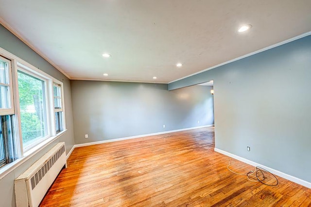 83 Bellerose Ave, East Northport, NY 11731 - unfurnished room with radiator heating unit, ornamental molding, recessed lighting, and light wood-style flooring