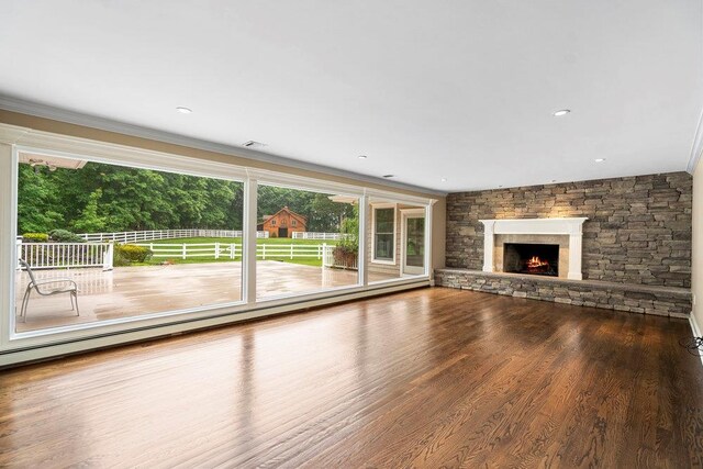 109 Oakside Dr, Smithtown, NY 11787 - unfurnished living room featuring a stone fireplace, wood finished floors, and ornamental molding