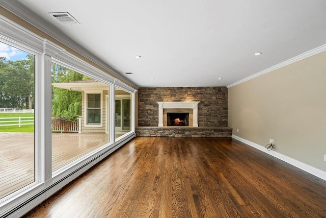 109 Oakside Dr, Smithtown, NY 11787 - unfurnished living room with a baseboard radiator, ornamental molding, wood finished floors, a stone fireplace, and recessed lighting