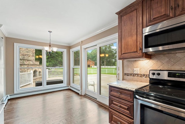 109 Oakside Dr, Smithtown, NY 11787 - kitchen featuring appliances with stainless steel finishes, decorative backsplash, a chandelier, ornamental molding, and hanging light fixtures
