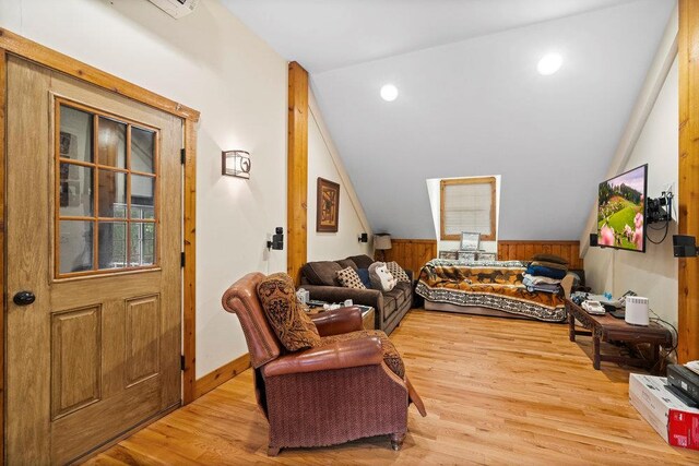 109 Oakside Dr, Smithtown, NY 11787 - living room featuring vaulted ceiling, light wood-style floors, wood walls, a wainscoted wall, and recessed lighting