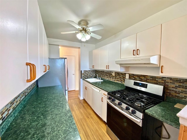 1 Sadore Ln Unit 7O, Yonkers, NY 10710 - kitchen featuring stainless steel appliances, under cabinet range hood, dark countertops, ceiling fan, and light wood finished floors