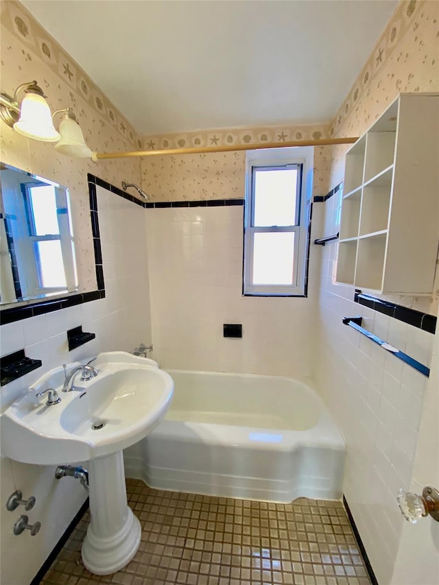 1 Sadore Ln Unit 7O, Yonkers, NY 10710 - bathroom with wallpapered walls, tile walls, plenty of natural light, shower / bathtub combination, and tile patterned flooring