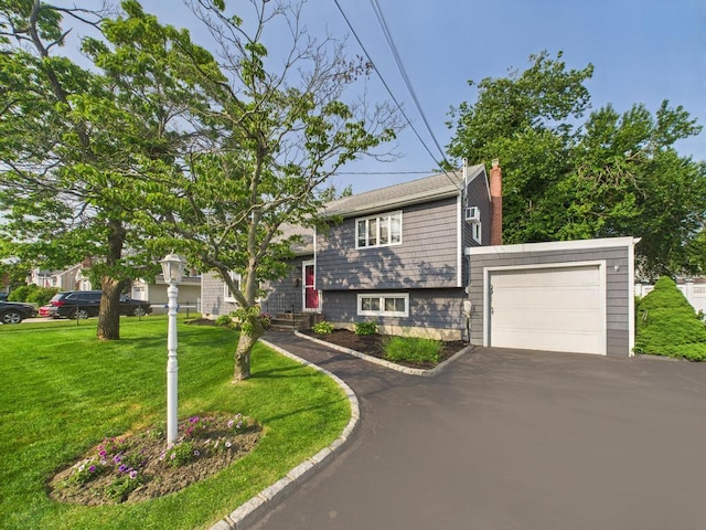 554 S 8th St, Lindenhurst, NY 11757 - split level home with driveway, a chimney, a front lawn, and a garage