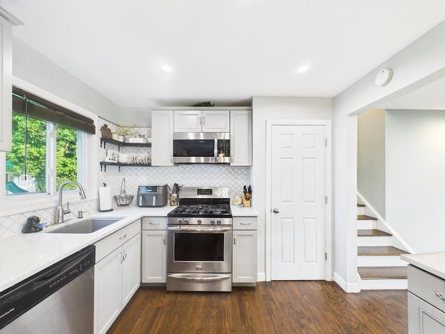 554 S 8th St, Lindenhurst, NY 11757 - kitchen featuring stainless steel appliances, light countertops, decorative backsplash, dark wood-style floors, and recessed lighting