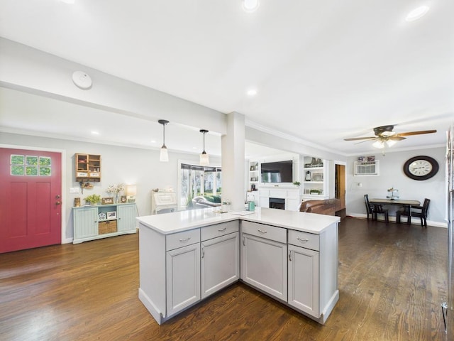 554 S 8th St, Lindenhurst, NY 11757 - kitchen featuring ceiling fan, a fireplace, gray cabinets, light countertops, and crown molding