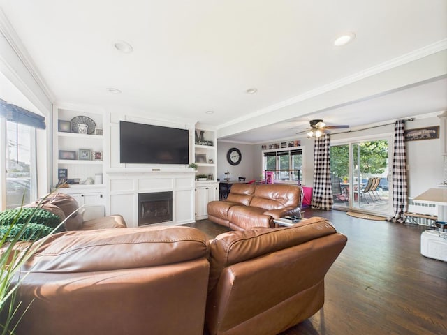 554 S 8th St, Lindenhurst, NY 11757 - living room featuring crown molding, a fireplace, a ceiling fan, dark wood finished floors, and built in features