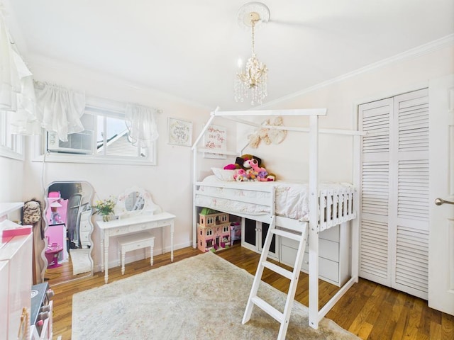 554 S 8th St, Lindenhurst, NY 11757 - bedroom featuring ornamental molding, a chandelier, wood finished floors, and cooling unit