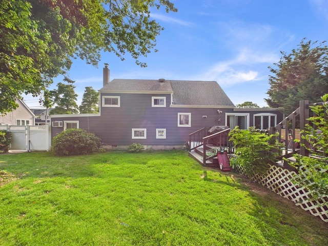 554 S 8th St, Lindenhurst, NY 11757 - rear view of house featuring a chimney, a gate, and a deck