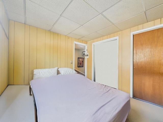 554 S 8th St, Lindenhurst, NY 11757 - carpeted bedroom featuring a paneled ceiling and wooden walls