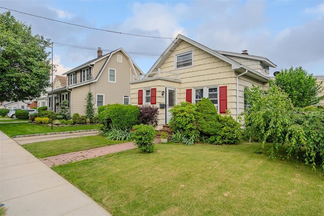 43 Westbury Ave, Mineola, NY 11501 - view of front of home with a front lawn and a chimney