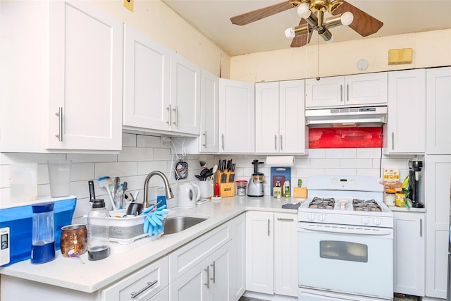 43 Westbury Ave, Mineola, NY 11501 - kitchen featuring white gas range oven, under cabinet range hood, ceiling fan, and decorative backsplash