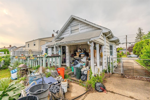 43 Westbury Ave, Mineola, NY 11501 - view of front of property with a gate and a shingled roof