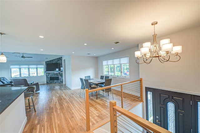 714 Montauk, West Islip, NY 11795 - corridor with light wood-style floors, healthy amount of natural light, a chandelier, and recessed lighting