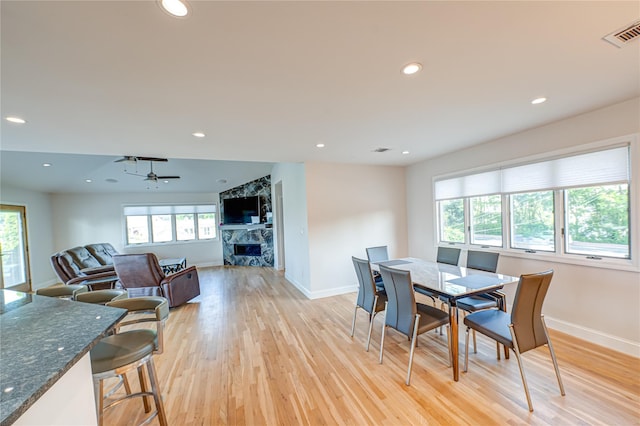 714 Montauk, West Islip, NY 11795 - dining space with healthy amount of natural light, light wood finished floors, a fireplace, and recessed lighting