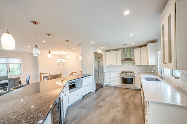 714 Montauk, West Islip, NY 11795 - kitchen with high quality appliances, wall chimney exhaust hood, decorative backsplash, a chandelier, and dark stone countertops